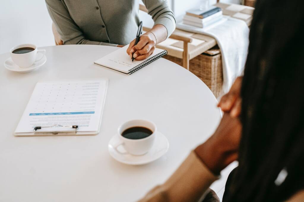 Interview between two people with a cup of coffee in between them
