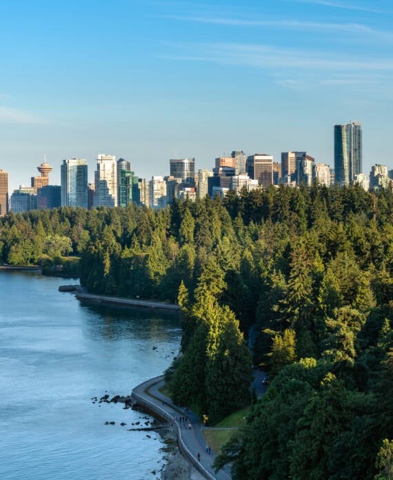 Vancouver skyline framed by forest and ocean, reflecting local death care rooted in place and community